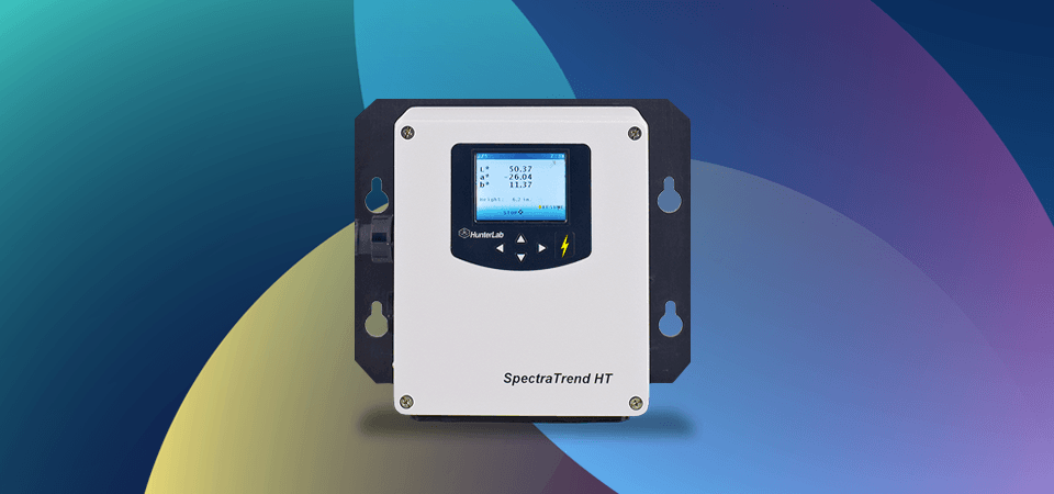 The HunterLab SpectraTrendHT spectrophotometer in front of a colorful background