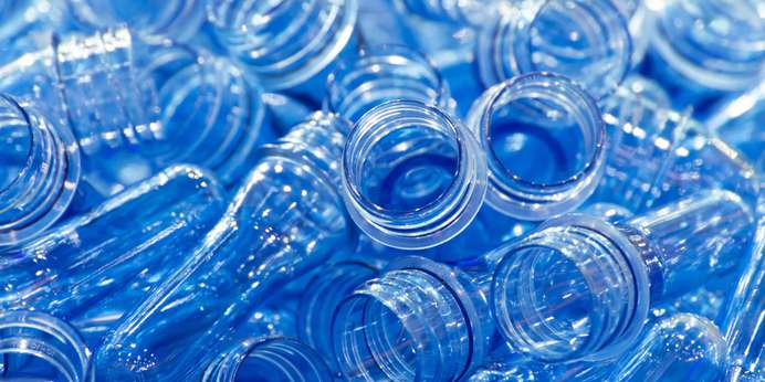 A pile of transparent plastic bottle preforms