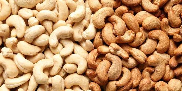 A pile of raw and roasted cashews